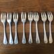 8 mismatched fish forks, silver metal