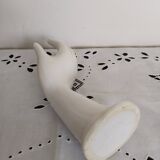 Hand holds white jewelry, ring sizer