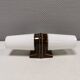 Old bathroom lamp with brown/golden ceramic base, porcelain socket and milky white glass