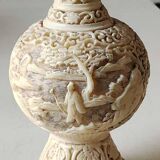 Asian-inspired ball vase. In beige cinnabar lacquer. Scenes of life decor. Arabesque and floral friezes. Height 24 cm