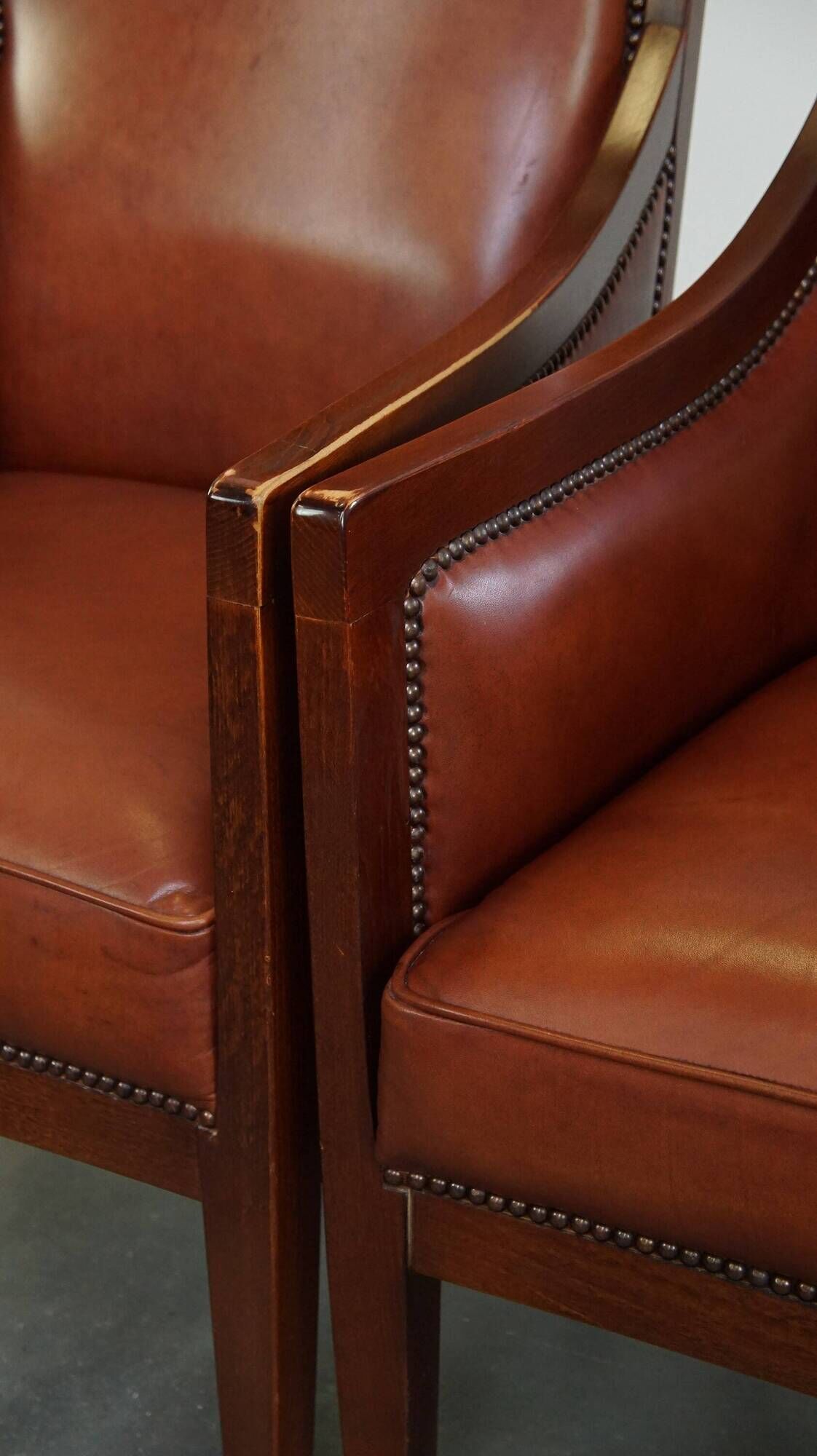 Majestic, luxurious set of 2 cognac-colored cowhide leather Art Deco design armchairs