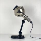 Directional articulated lamp in nickel-plated chrome and black bakelite, with cast iron counterweight.