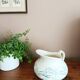 Old bulbous jug in ironstone earthenware