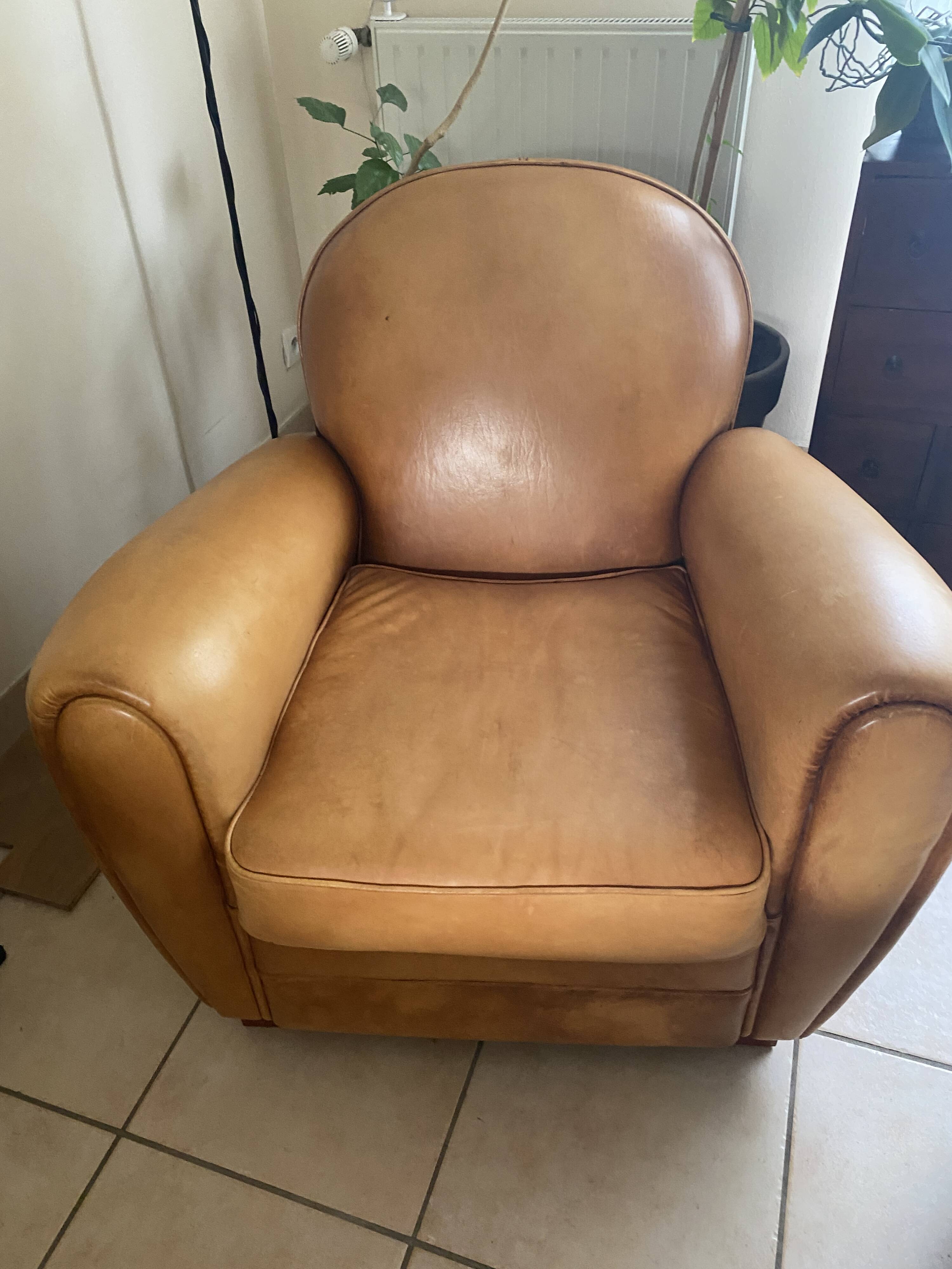 Brown leather club armchairs with an antique finish.