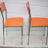 Pair of chrome metal chair and orange skai