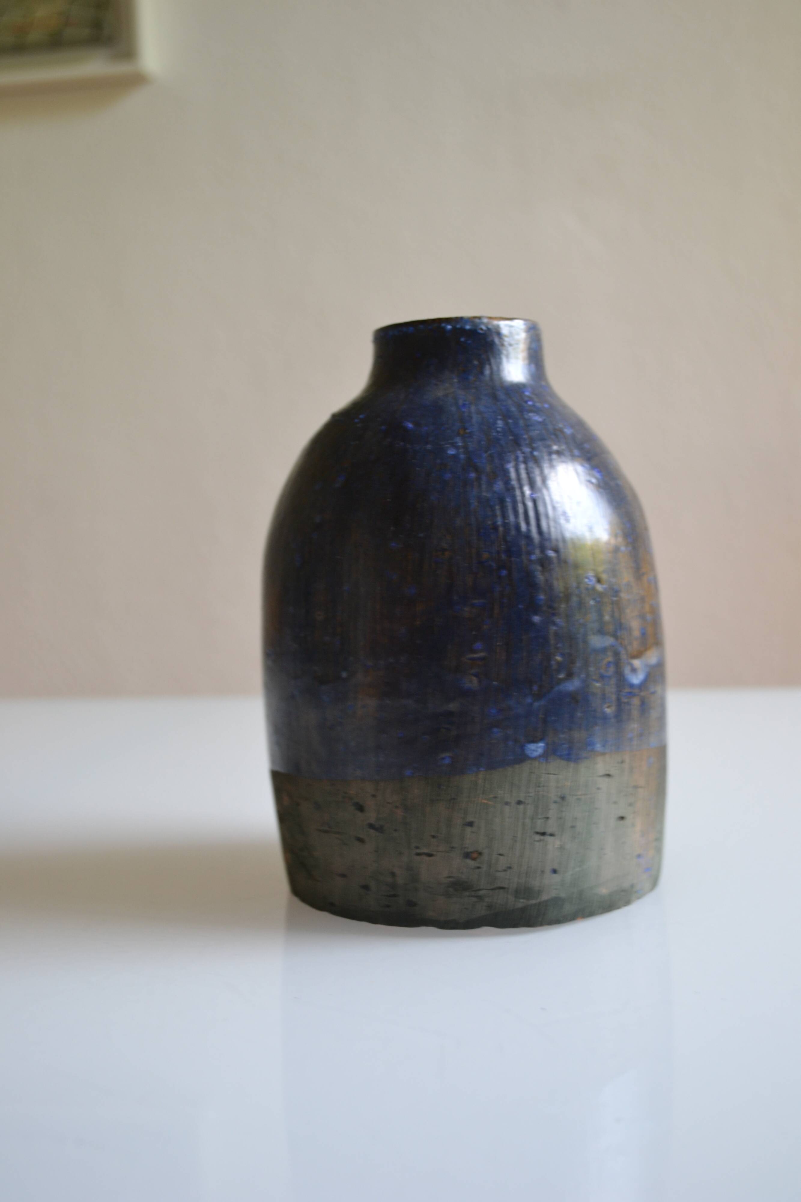 Ceramic bottle vase with a fish signature to be identified.