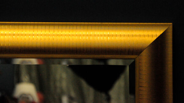 Large mirror in a golden decorative frame