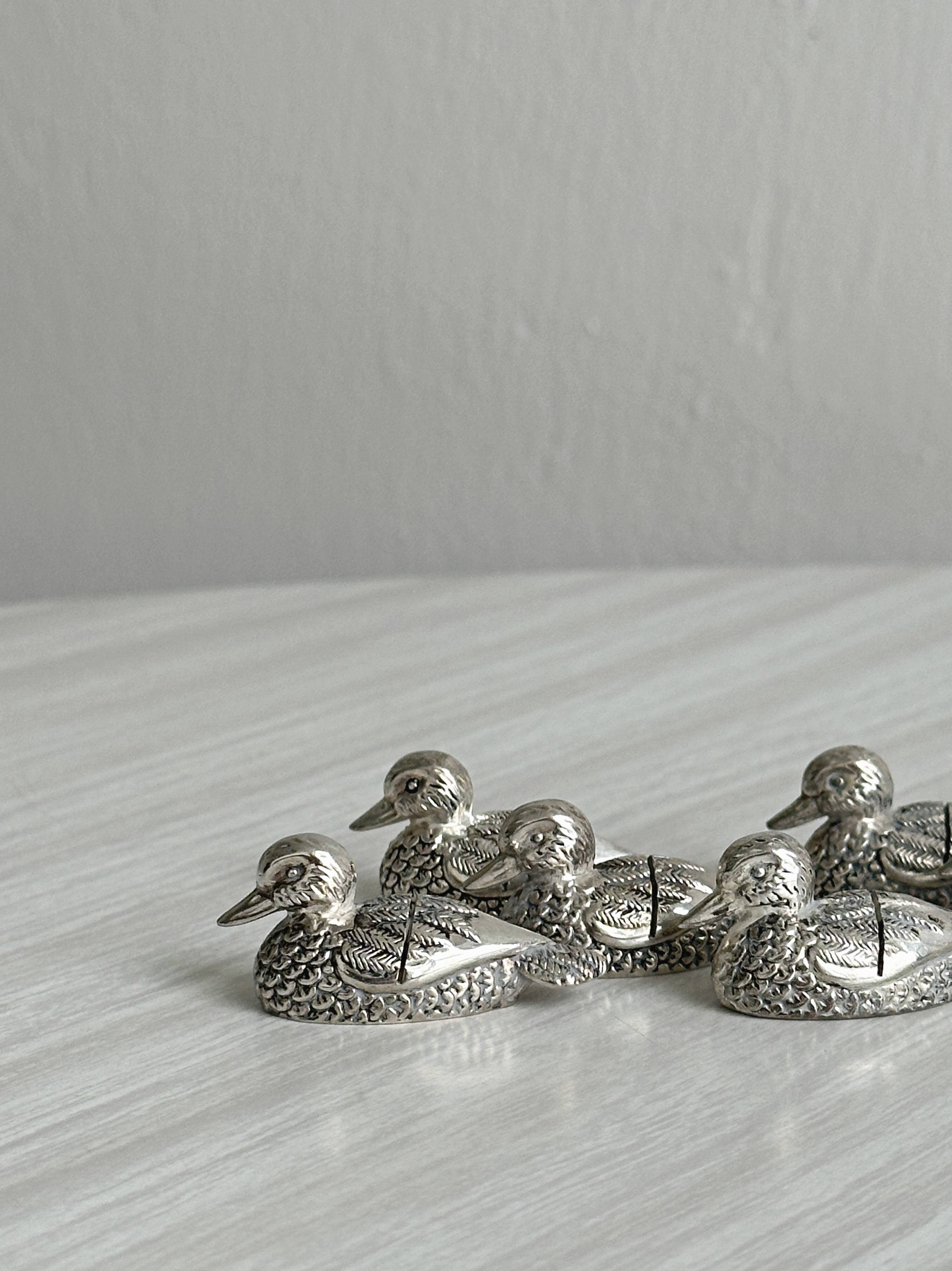Set of 6 silver-plated metal ducks, name holders and knife rests.