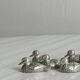 Set of 6 silver-plated metal ducks, name holders and knife rests.