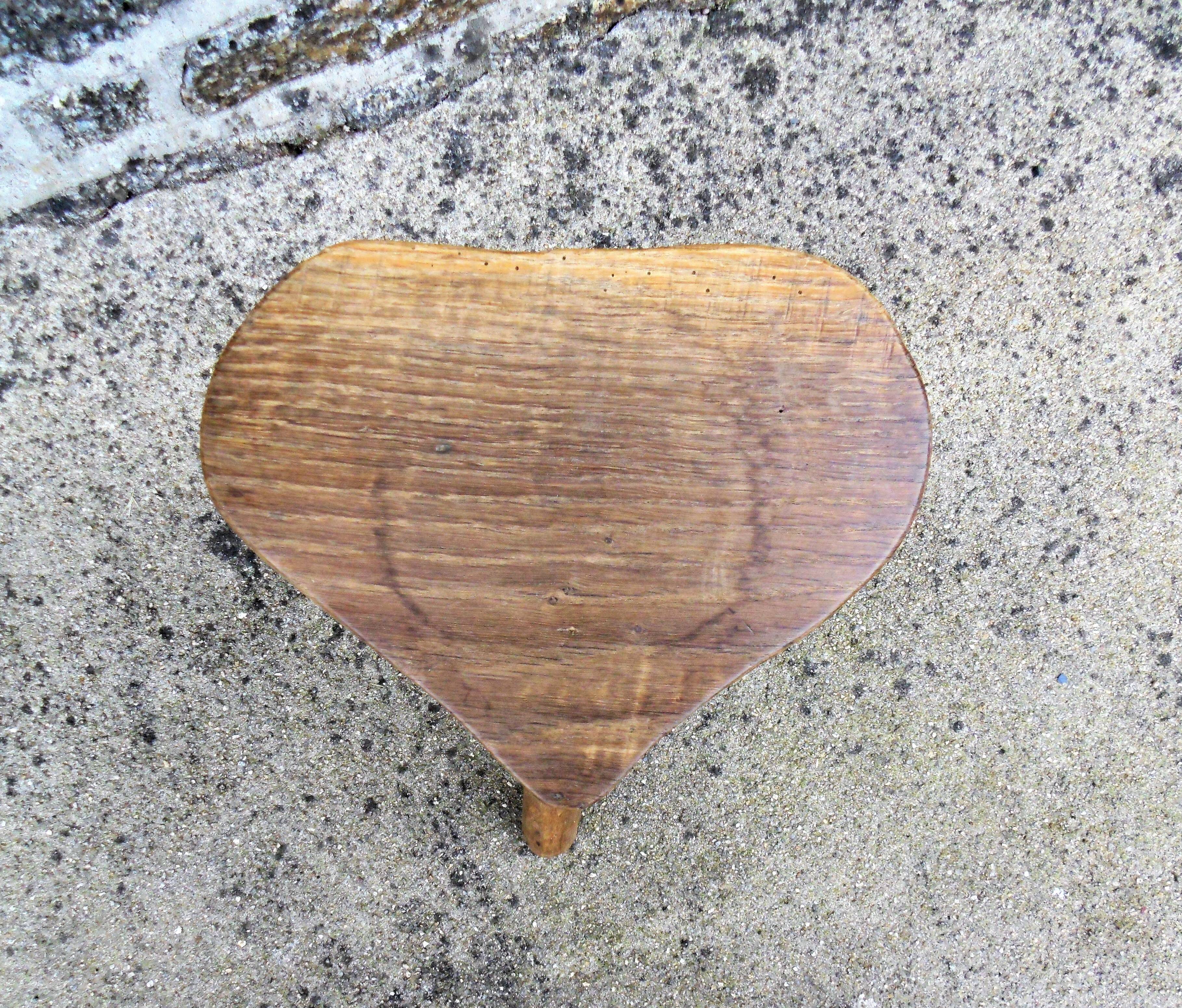 Farm stool in raw wooden sitting in the shape of a popular art