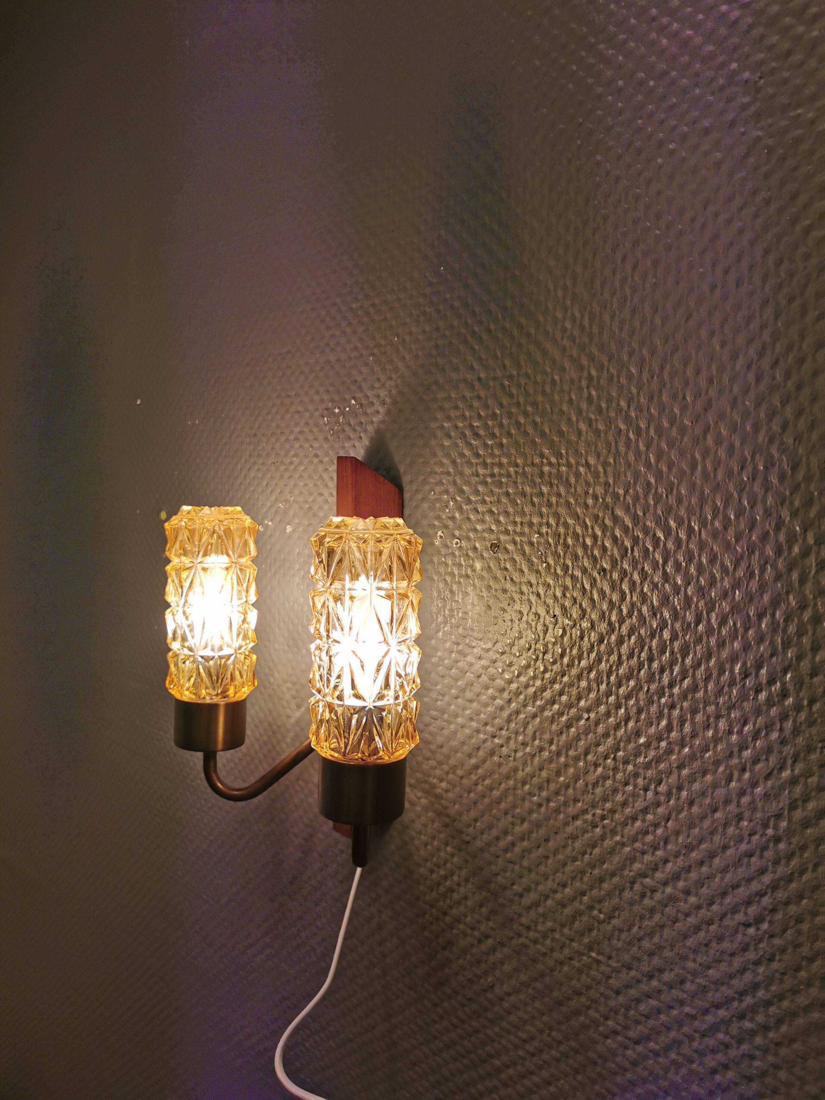 Older Danish wall lamp, with double light source, made of teak wood, amber colored glass and brass