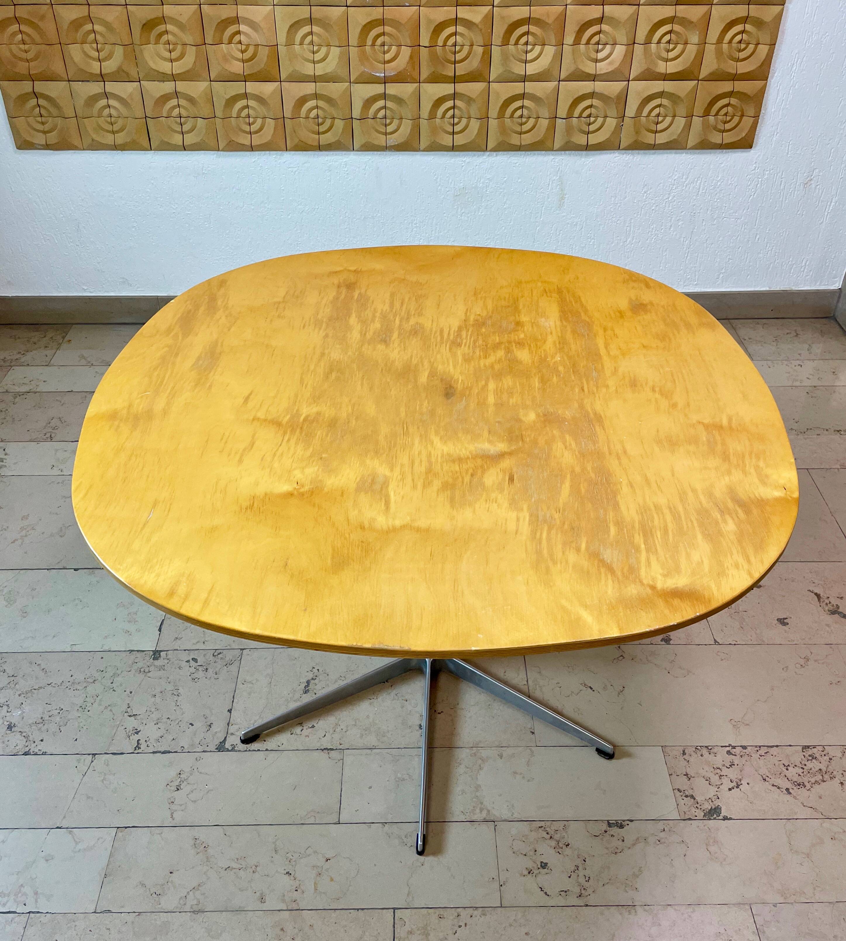 Dining table with a star-shaped six-legged base by Arne Jacobsen for Fritz Hansen.