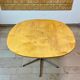 Dining table with a star-shaped six-legged base by Arne Jacobsen for Fritz Hansen.