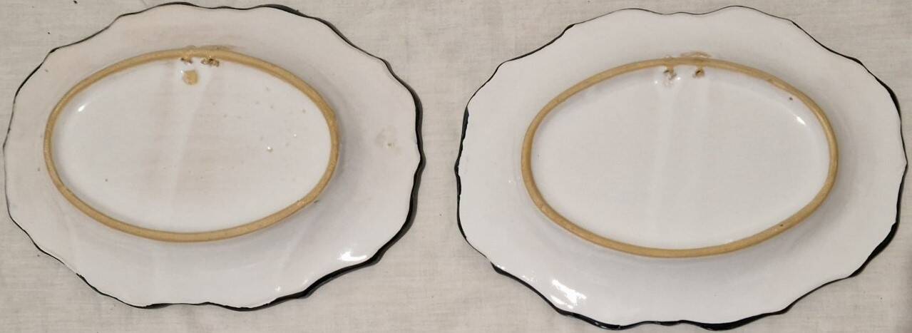 Pair of oval dishes in hand-painted faience with an Italian majolica spirit.