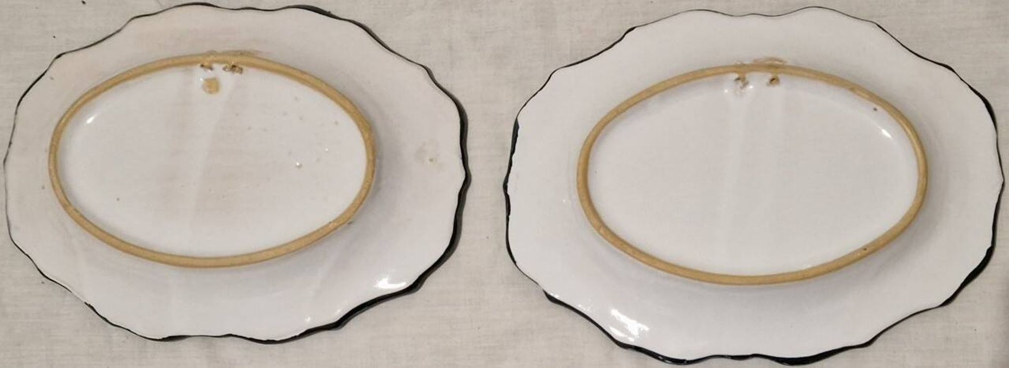 Pair of oval dishes in hand-painted faience with an Italian majolica spirit.