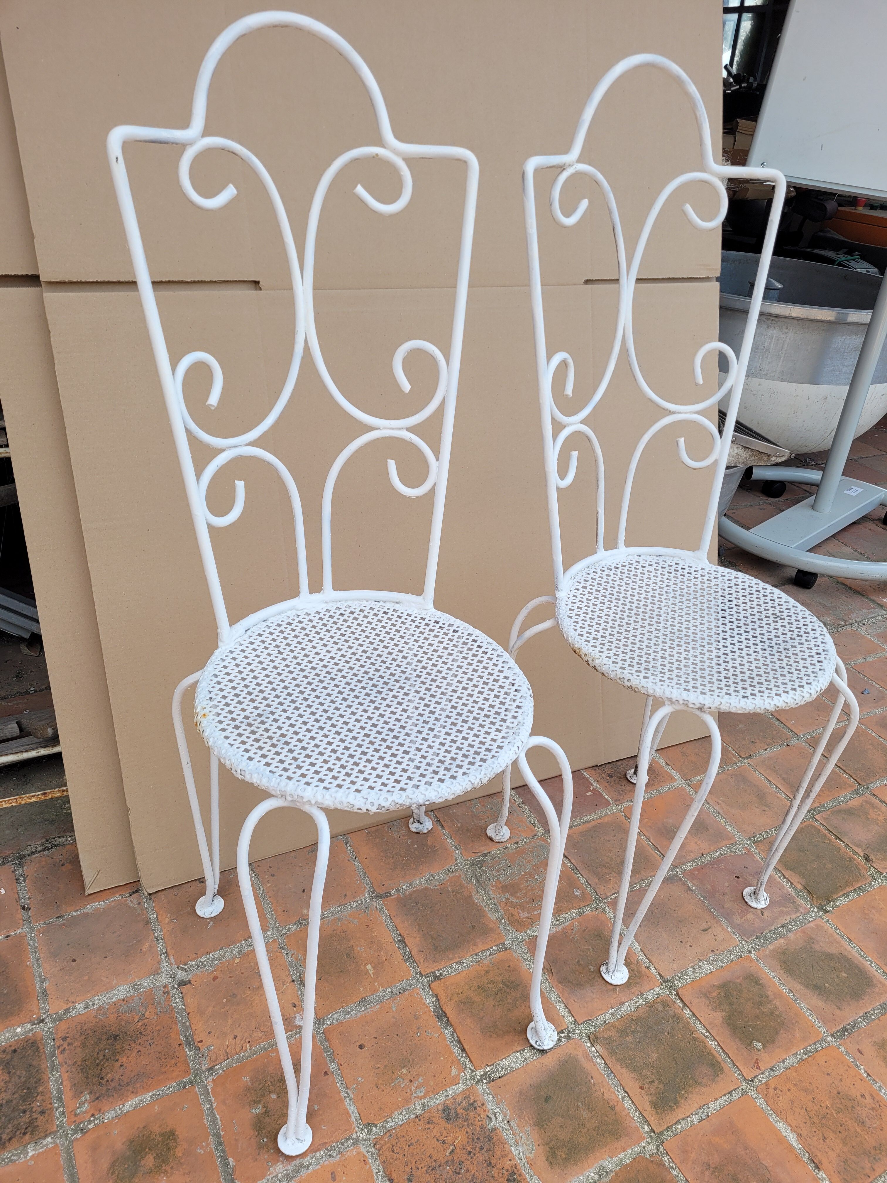 Pair of antique wrought iron garden chairs