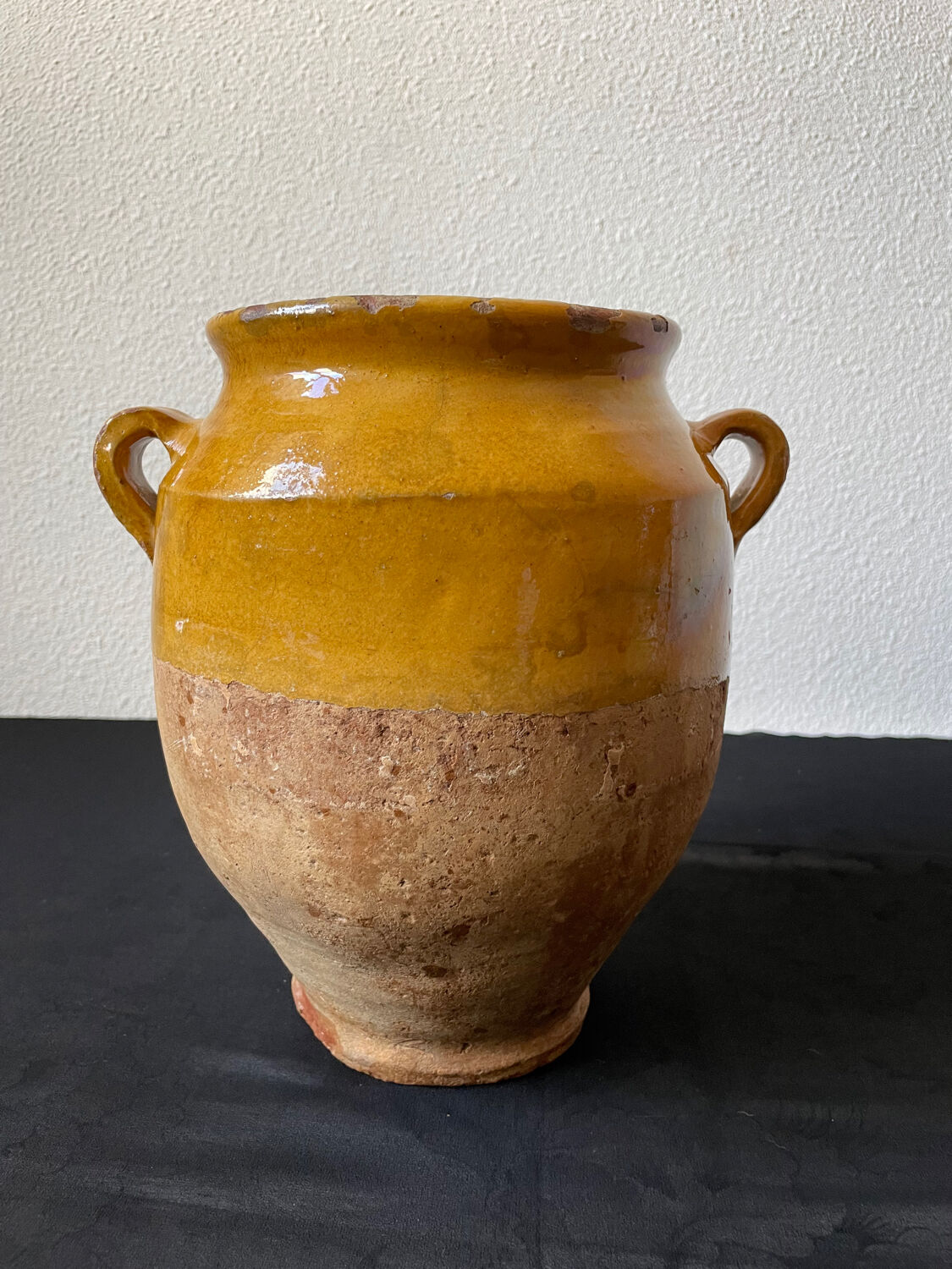 Old candied pot in yellow glazed terracotta