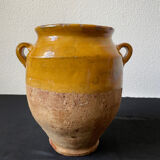 Old candied pot in yellow glazed terracotta