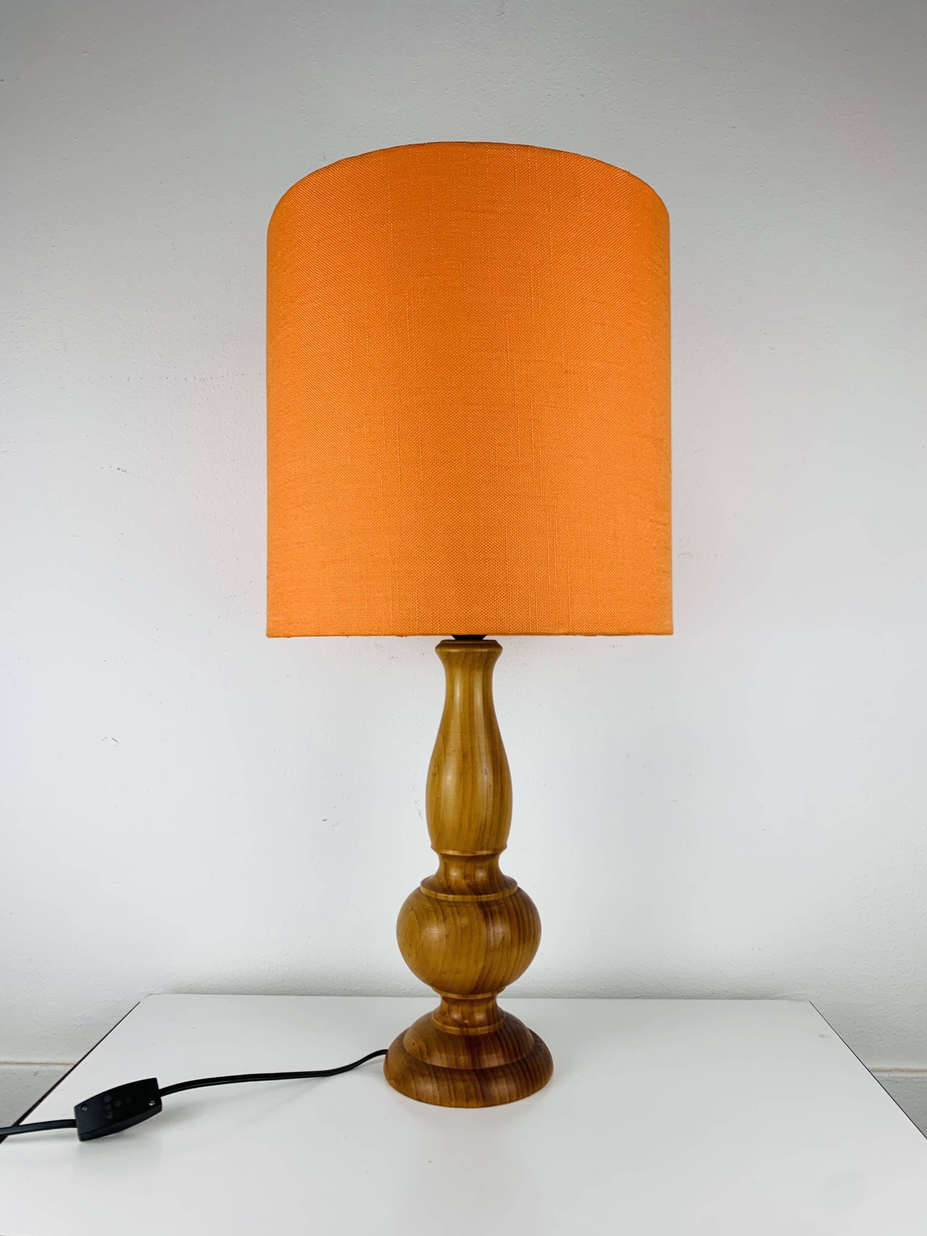 Turned wood lamp with orange shade, 1970s.