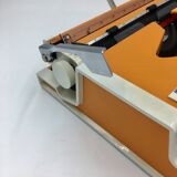 WE typewriter orange