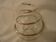 Round glass candle holder with silver-plated metal spiral.