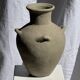 Light beige-grey Indonesian terracotta vase with 4 small handles and a high neck.