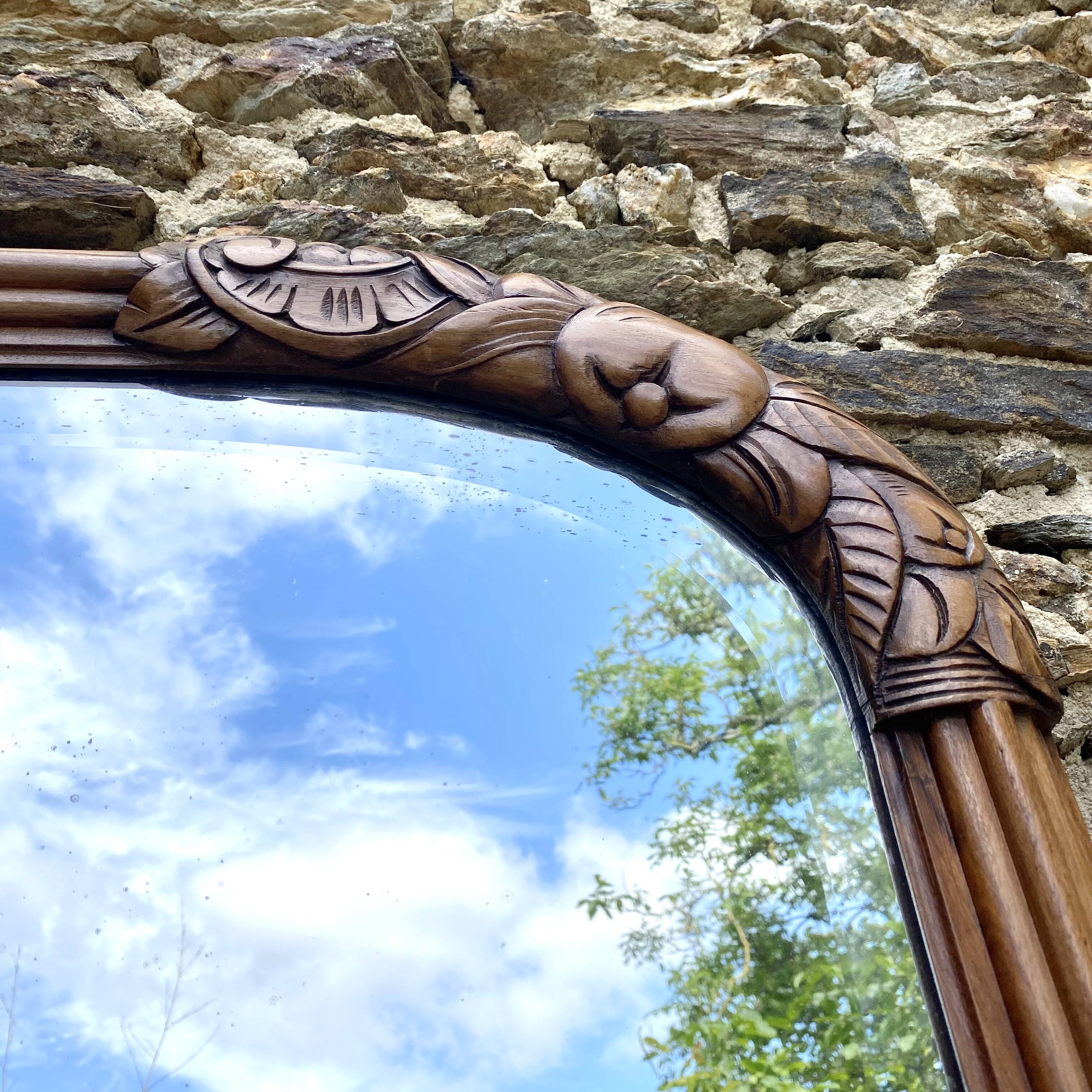 Beveled art deco mirror, carved wood