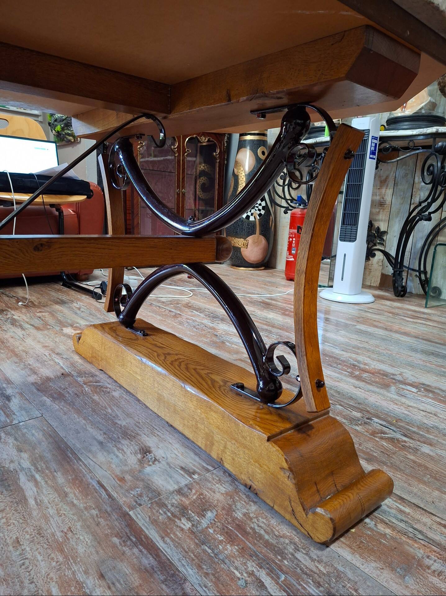 Large polished granite dining table on an oak and iron base.