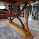 Large polished granite dining table on an oak and iron base.