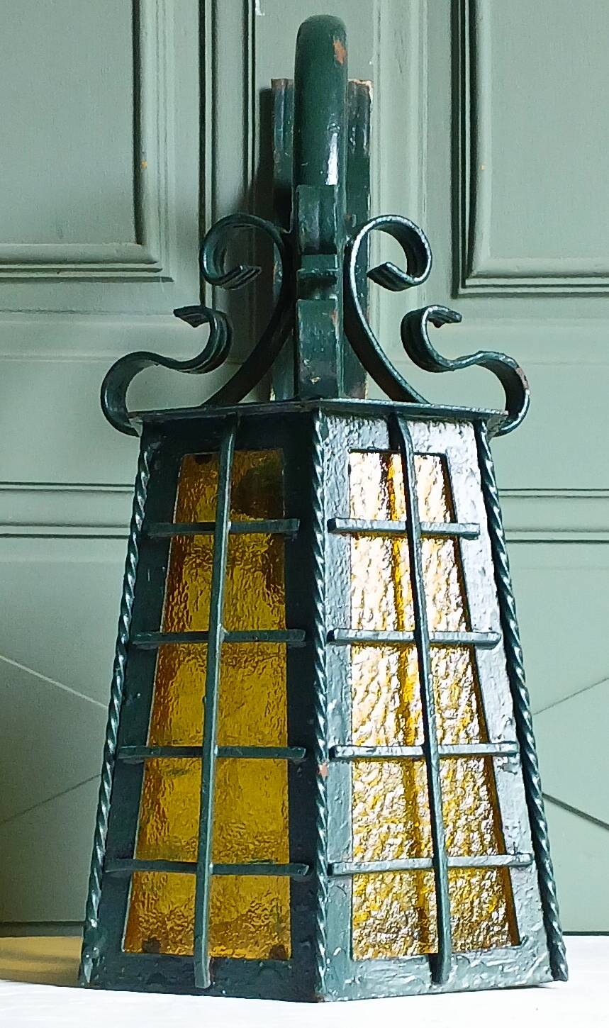 Wrought iron wall lantern & amber cathedral glass