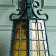 Wrought iron wall lantern & amber cathedral glass