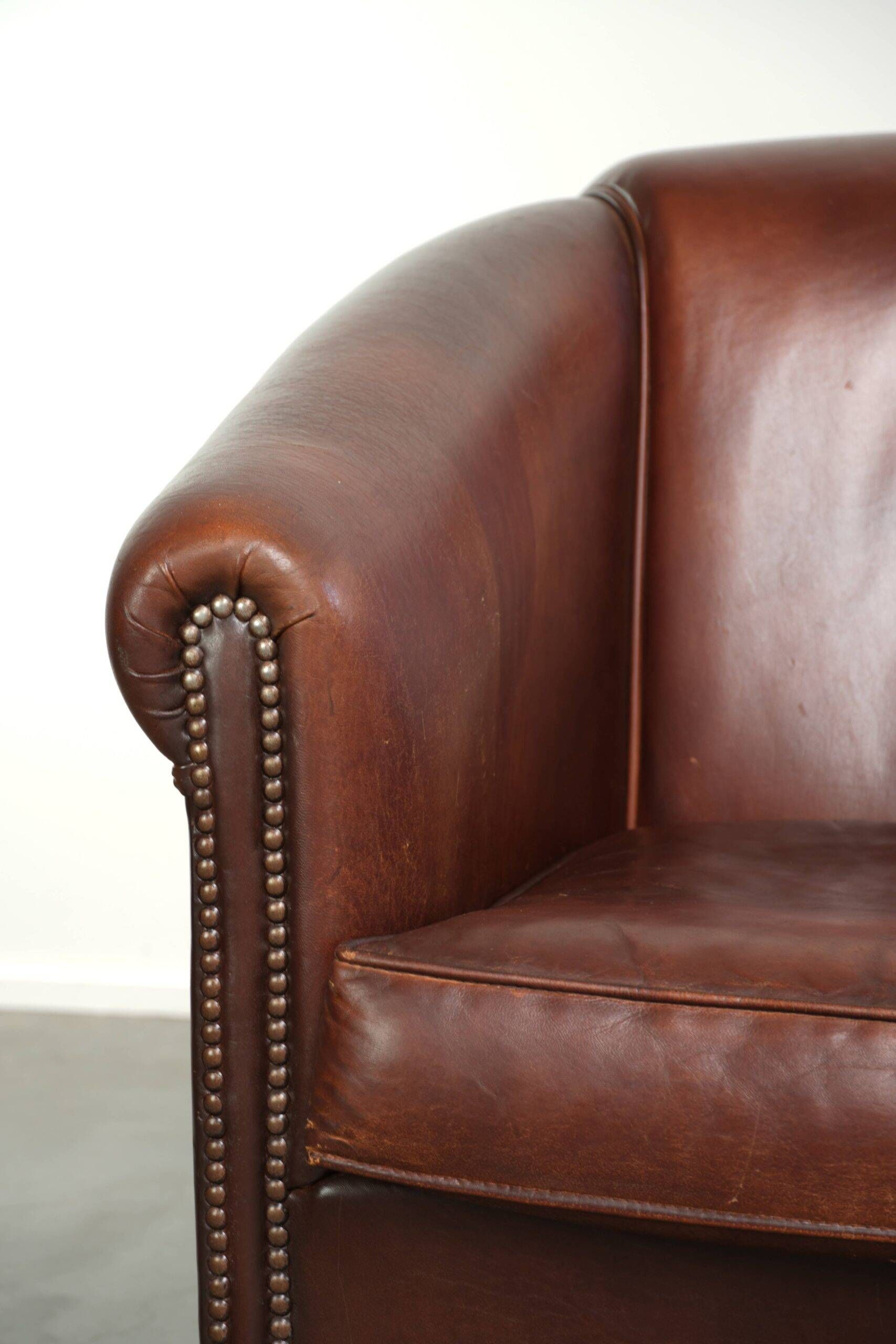 Sheepskin club armchair in English style with brown colour scheme