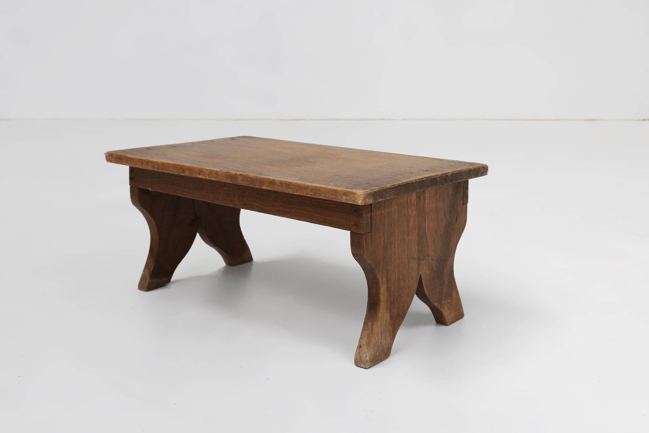 Small rustic wooden stool with curved base, France ca. 1900