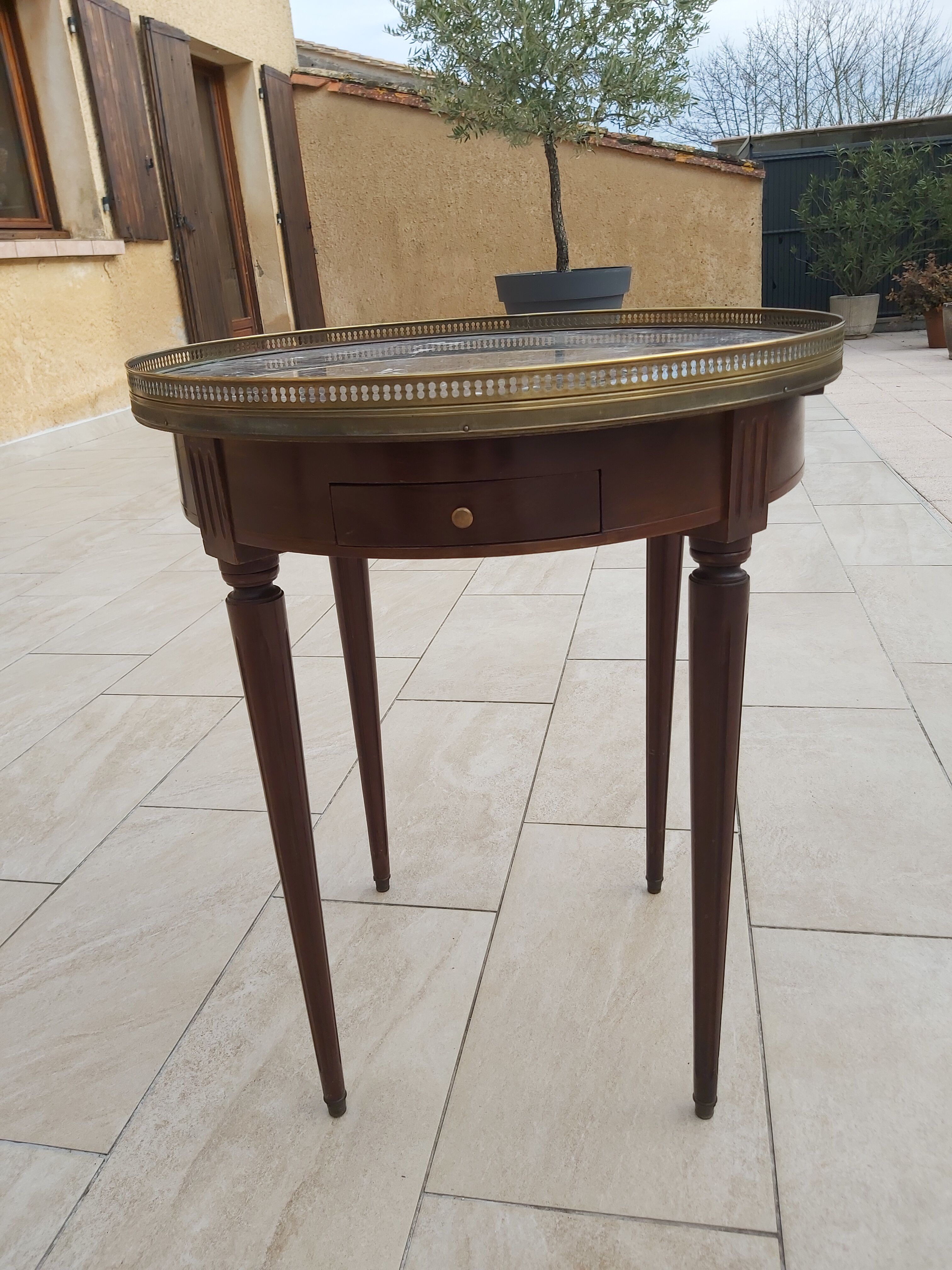 Gray marble mahogany pedestal table and brass gallery