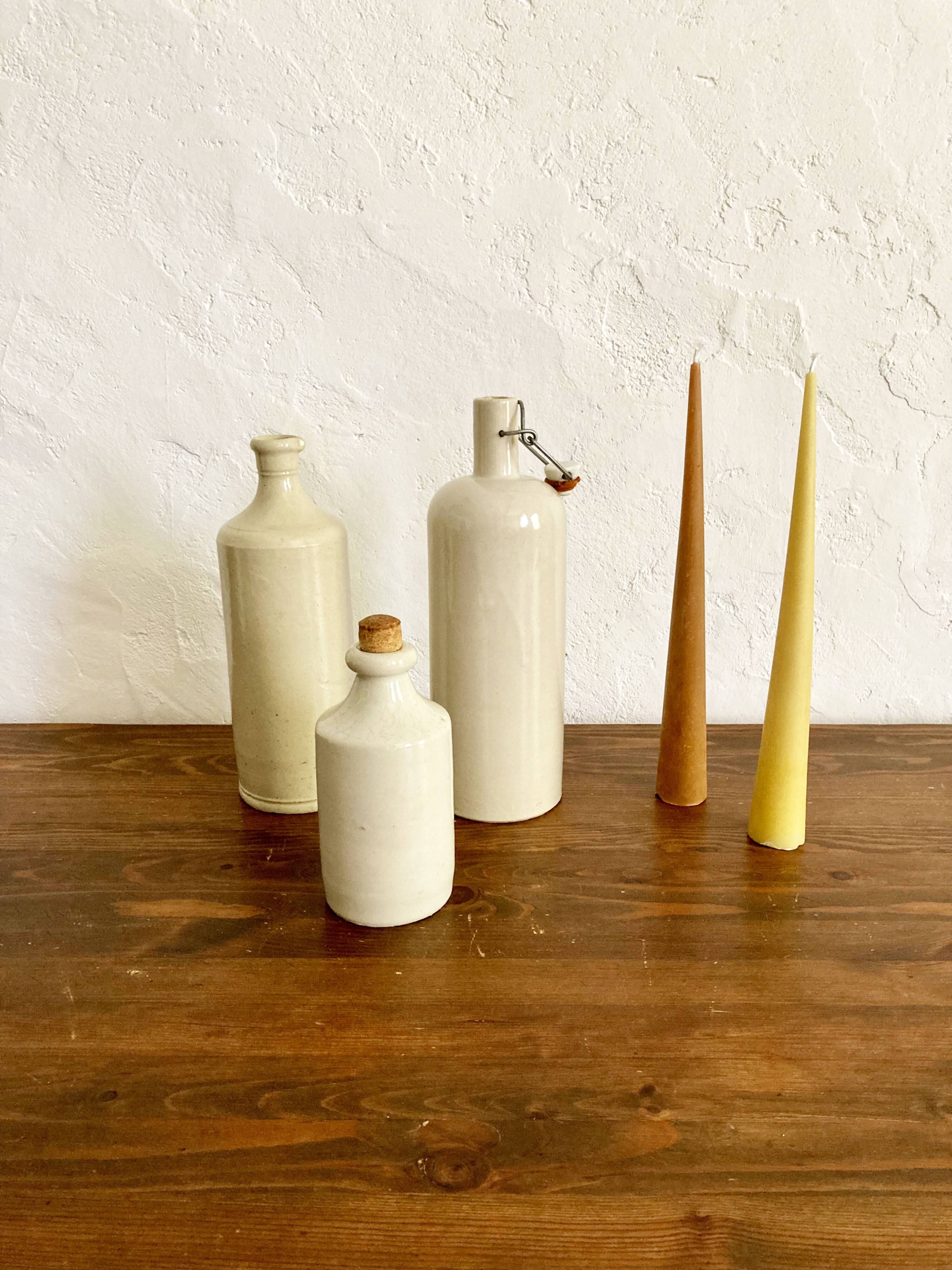 Trio of creamy white glazed stoneware bottles