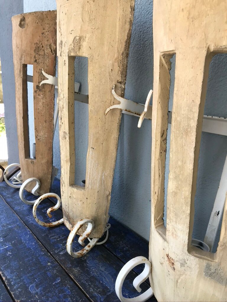 Lot of three terracotta and wrought iron appliques