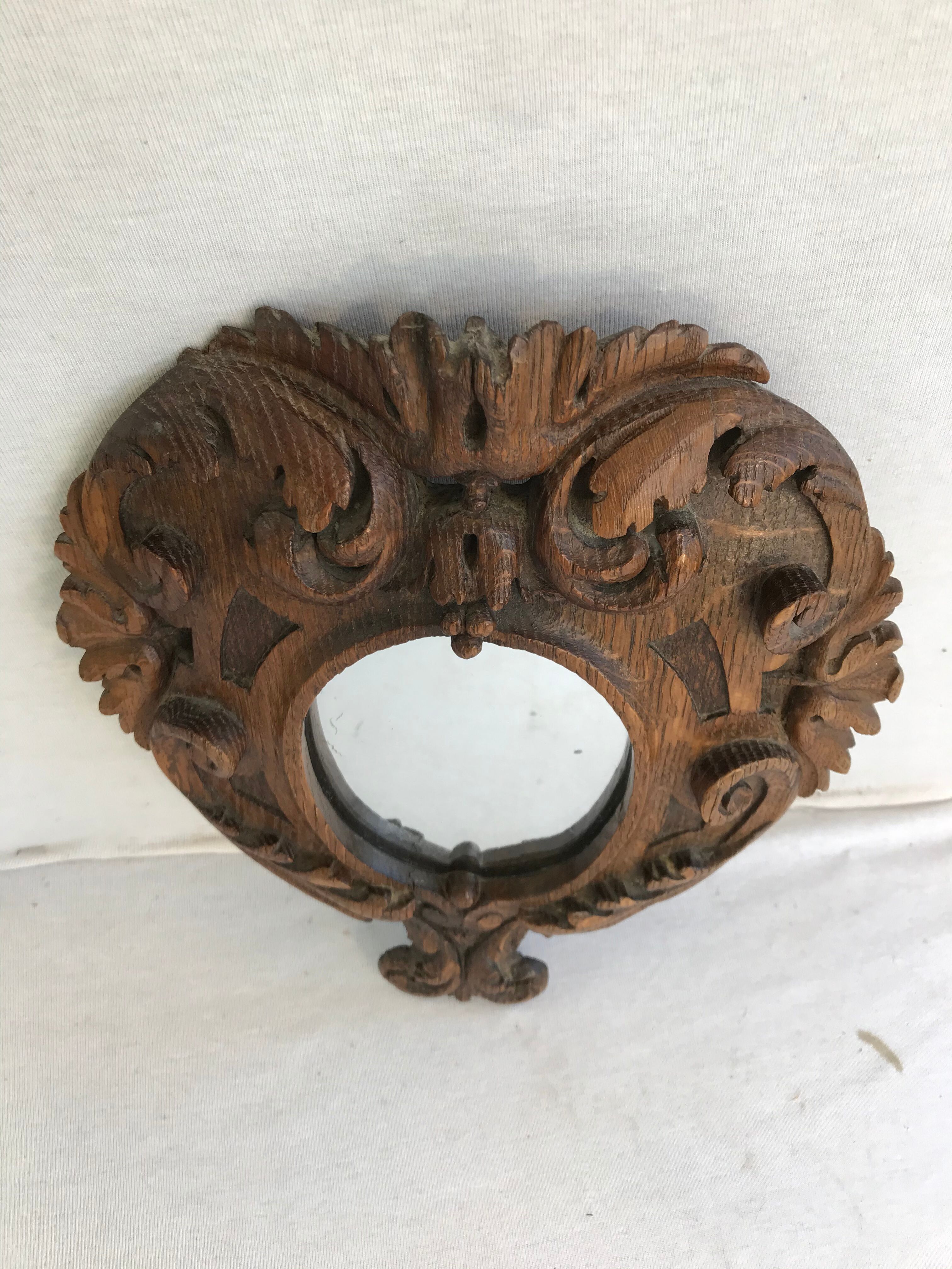 Ancient mirror in carved wood, vintage decoration