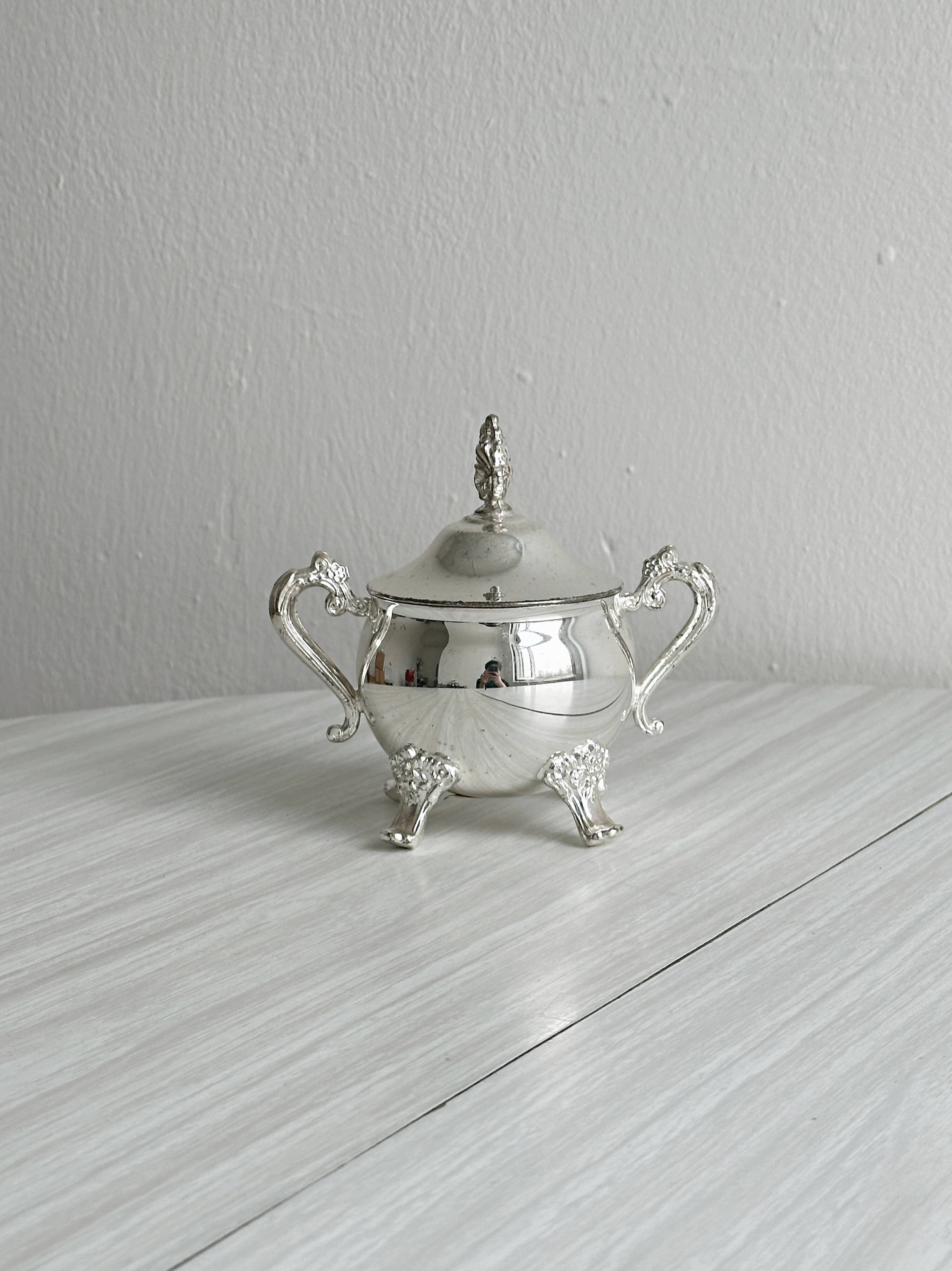 Antique shiny metal sugar bowl