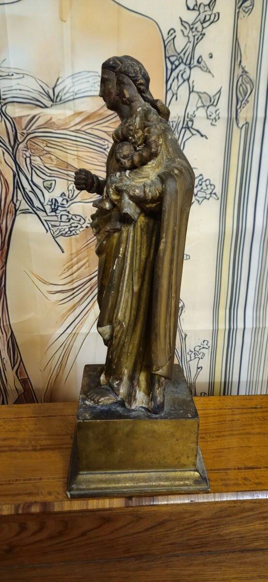 Ancient statue of the Virgin and Child in polychrome and gilded carved wood.