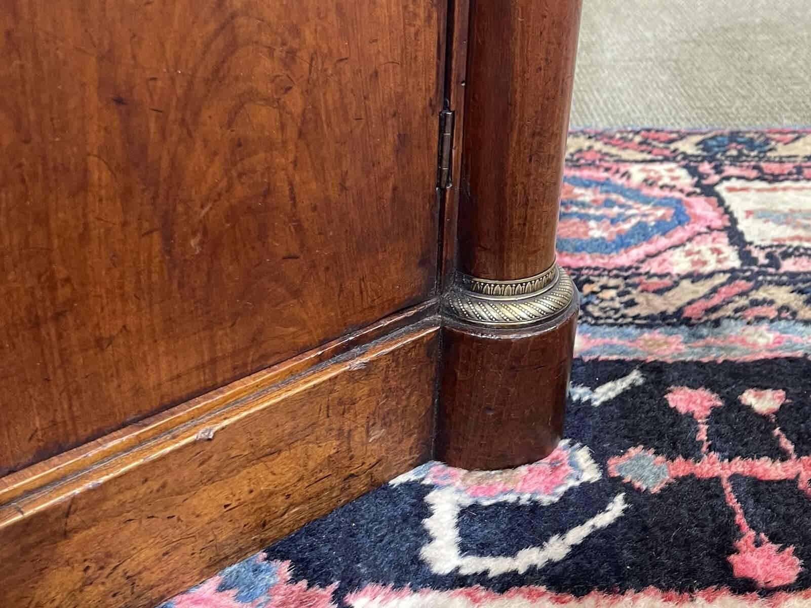 Empire bedside table from the 19th century in cherry wood and black marble.