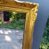 narrow gilded mirror in Louis XV style