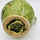 Green stoneware pitcher with flower and brown bird decoration