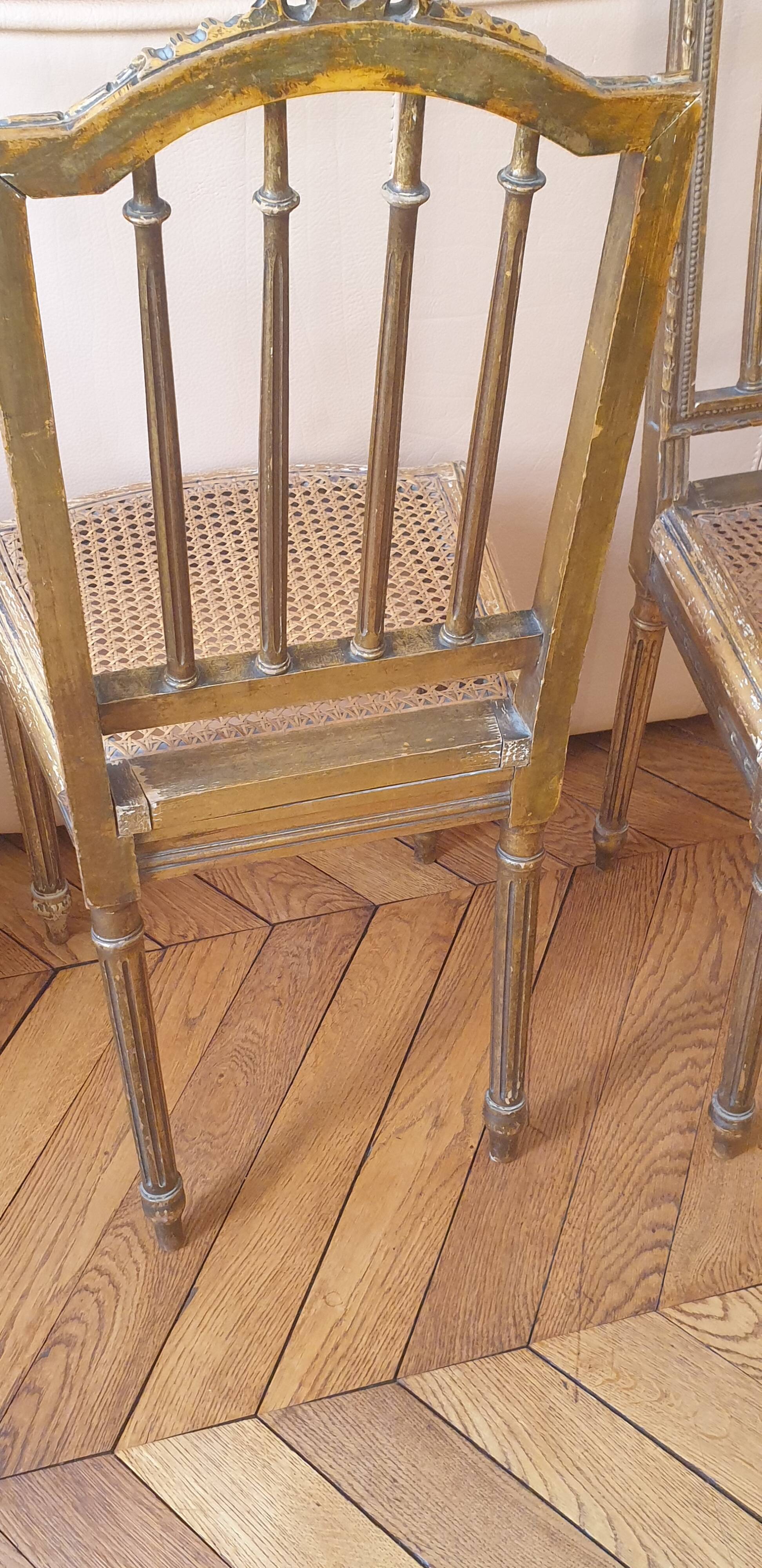 Pair of Louis XVI caned chairs with carved gilded wood.
