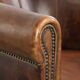 Sheepskin clubarmchair with beautiful patina finished with decorative nails