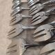 12 silver-plated oyster forks with rocaille ribbon decoration, 13.7 cm