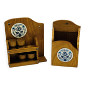 Wall-mounted egg cup holder and wooden utensil holder.