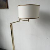 Floor lamp with articulated arm in brass-plated metal