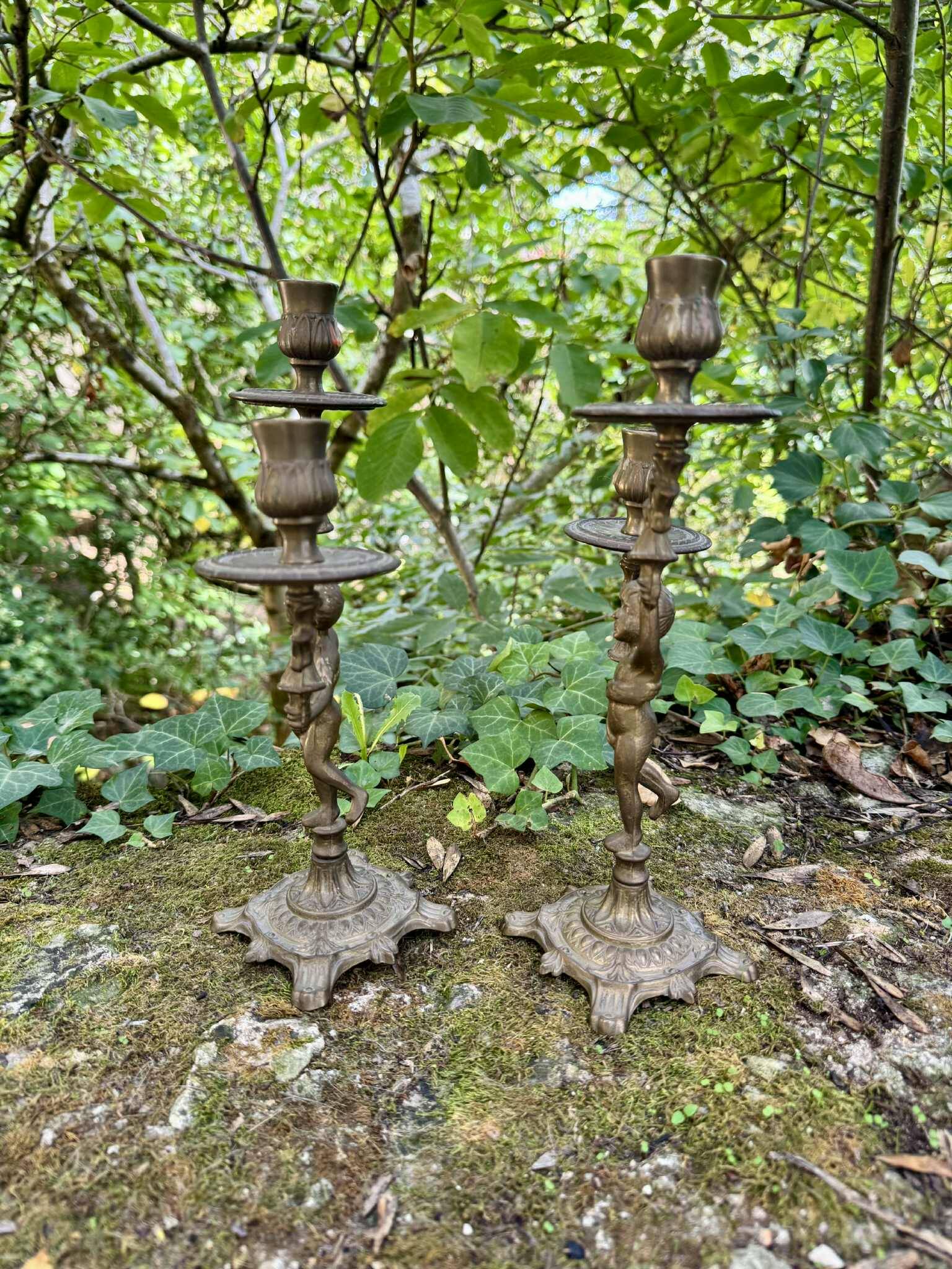 Pair of brass cherub candlesticks
