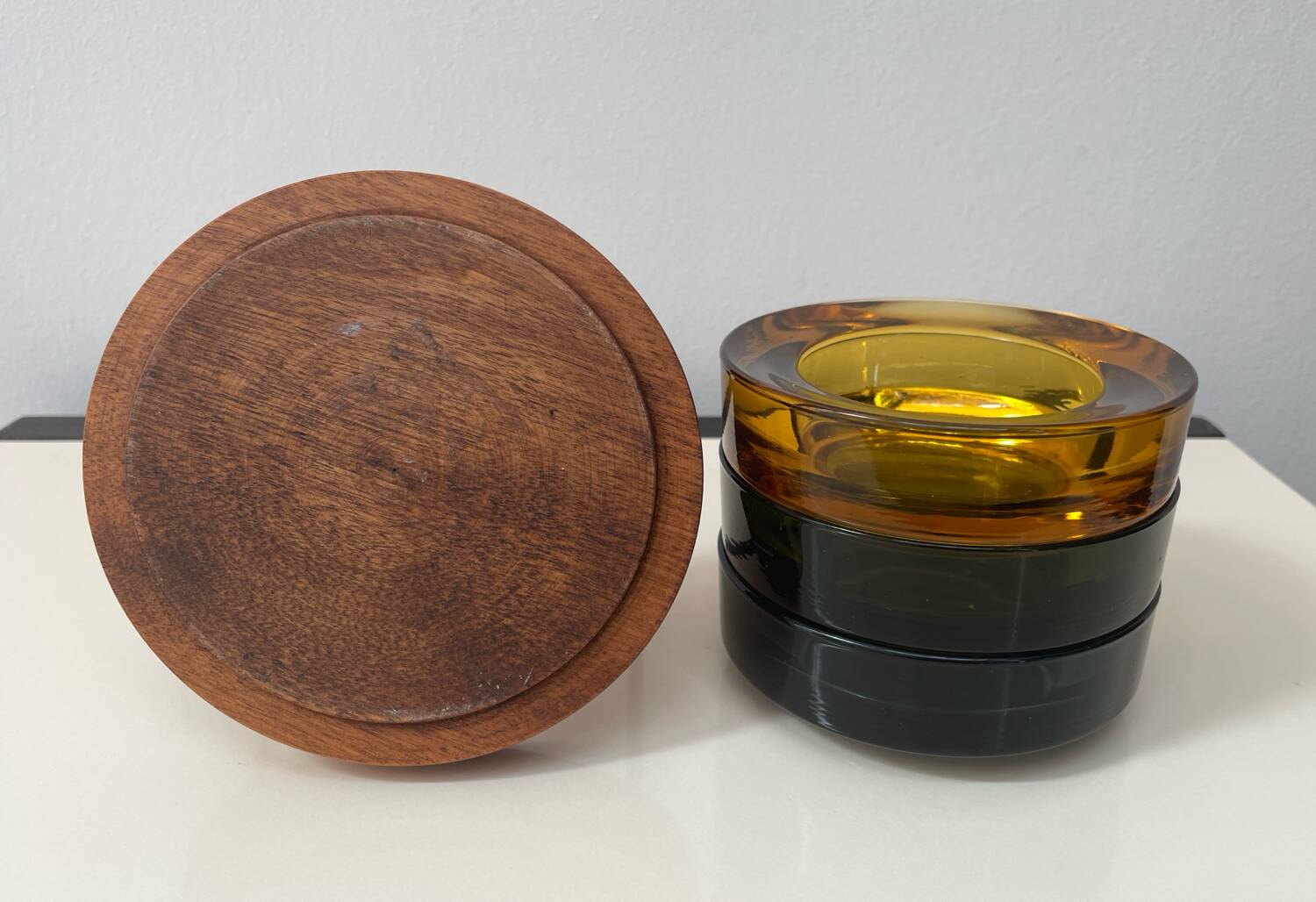 Set of 3 stackable glass catchalls with a teak base.