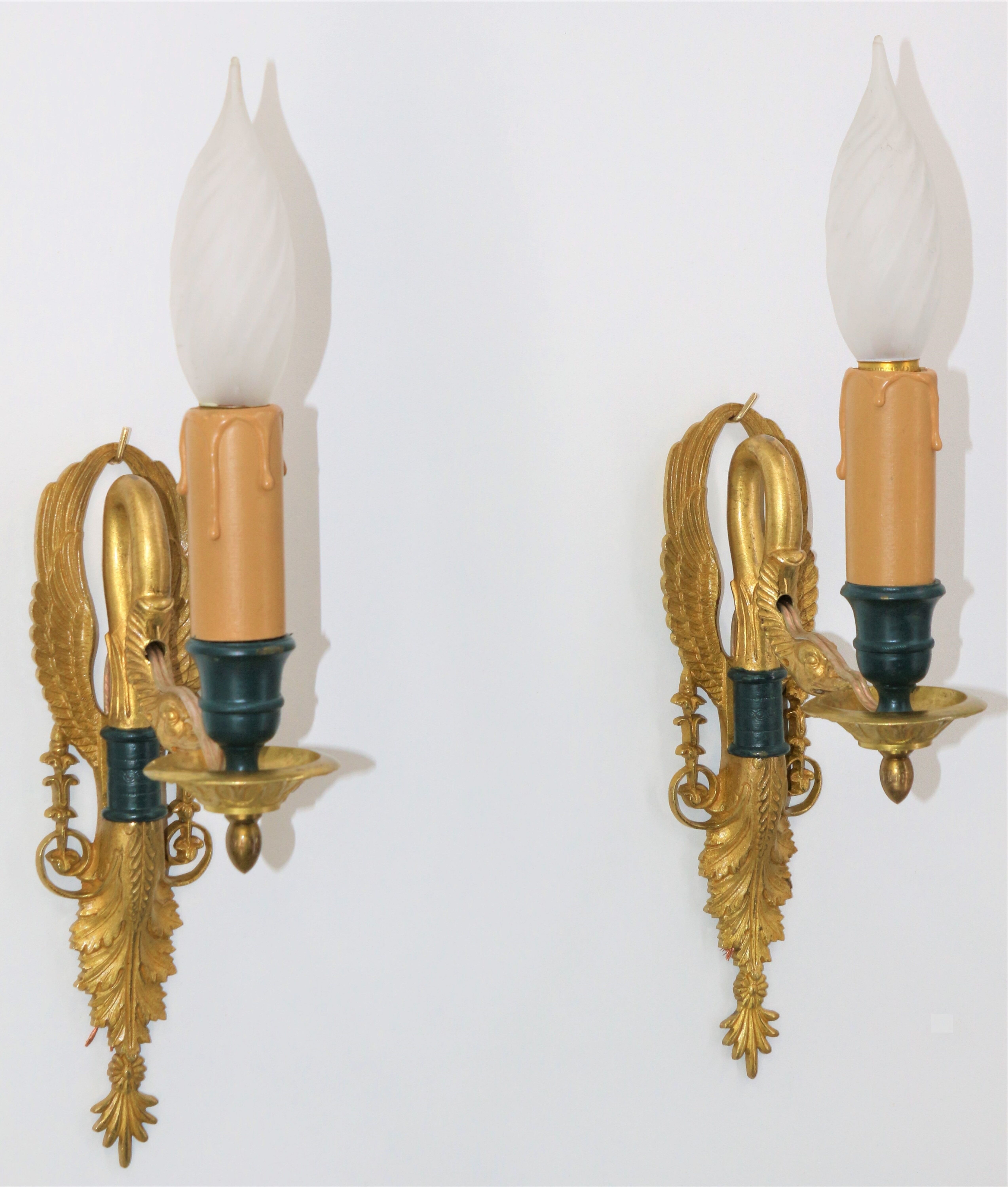 Pair of golden bronze wall lamps in triumphant empire swan style